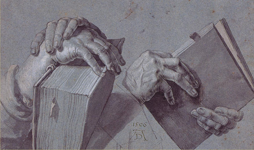 Two Hands Holding a Pair of Books